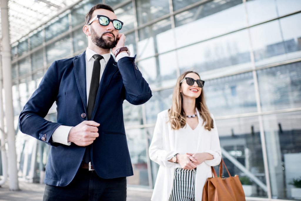 Business woman with security outdoors